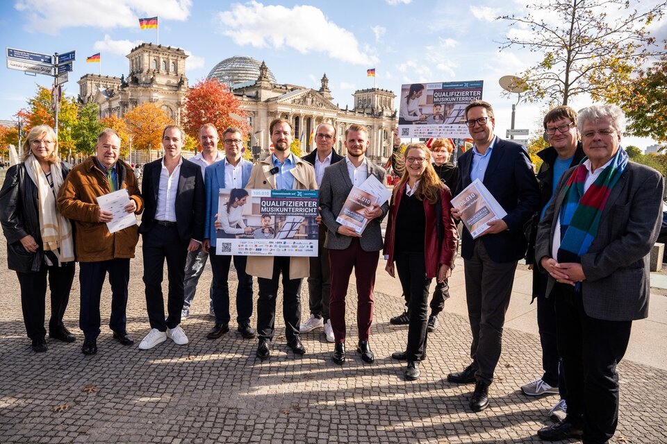 Tim Klüssendorf (5. v. r.) und Markus Herbrand (3. v. r.) mit den ausgedruckten und gebundenen 100.000 Unterschriften der Petition